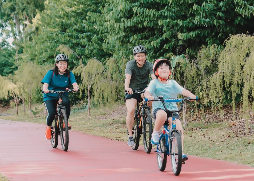 Family of 3 cycling along the Changi Airport Connector.